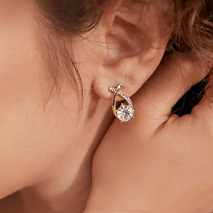 Boucles d'oreilles avec croix dorée et zirconium